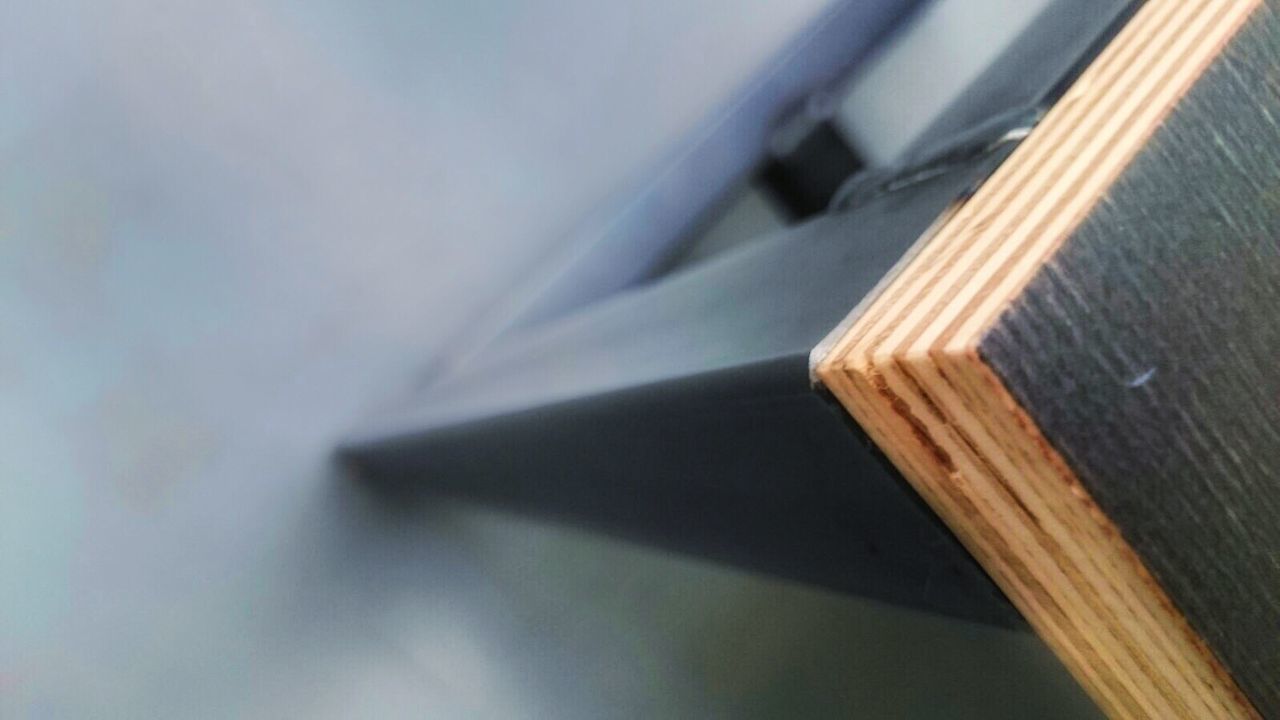 CLOSE-UP OF WOODEN FLOOR AGAINST WALL