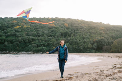 Full length of man standing on beach