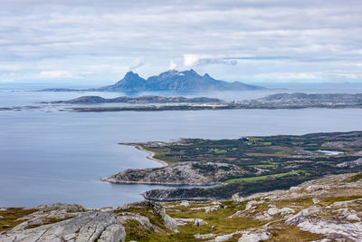 Scenic view of sea and mountains against sky