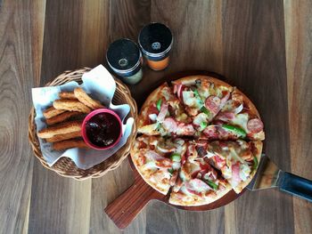 High angle view of pizza served on table