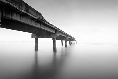 Pier over sea against clear sky