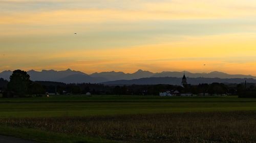 Scenic view of silhouette mountains against sky at sunset