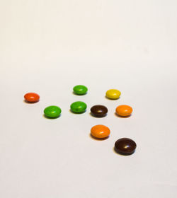 High angle view of candies against white background