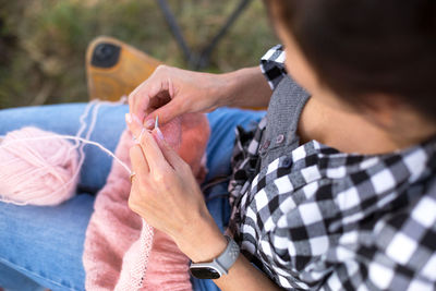 Midsection of woman knitting