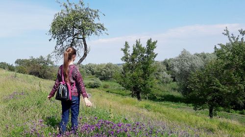 Rear view of teenage girl standing in forest