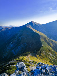 Scenic view of mountains against blue sky. picture taken in front of the giewont peak