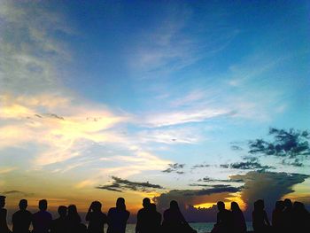 Silhouette people against sky during sunset