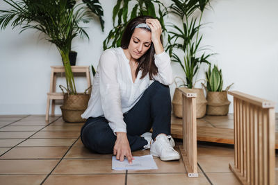 Woman repairing furniture at home