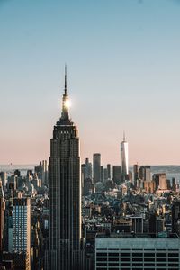 Modern buildings in city against clear sky