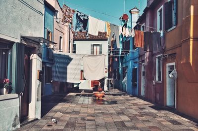 Clothes drying on street amidst buildings