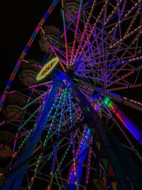 Low angle view of illuminated ferris wheel at night