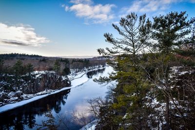 Scenic view of river against sky during winter