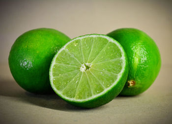 Close-up of green fruit against white background