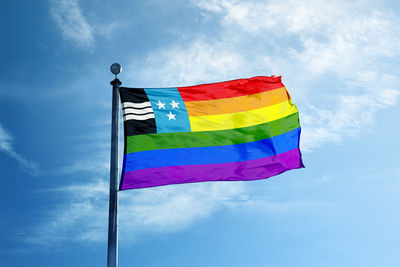 Low angle view of flags against blue sky