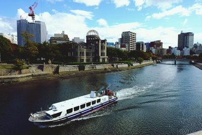 Boats in river with buildings in background