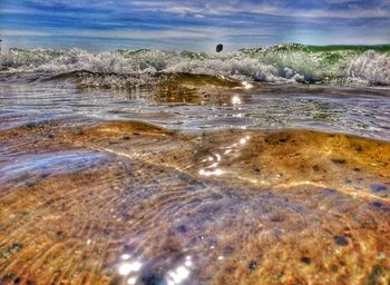 Surface level of beach against sky