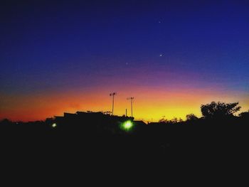 Silhouette of trees against sky at sunset