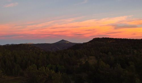 Scenic view of mountains against sky at sunset