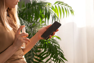 Midsection of woman using mobile phone