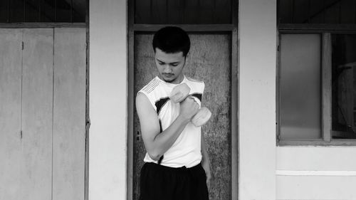 Full length of a boy standing against wall