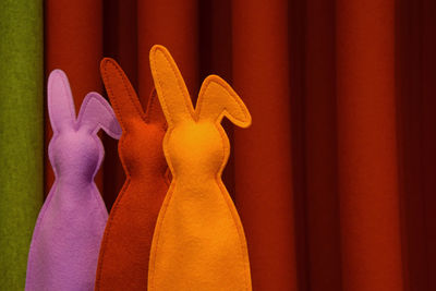 Colorful easter bunnies against curtain