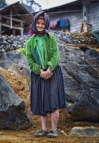 Portrait of woman standing on rock