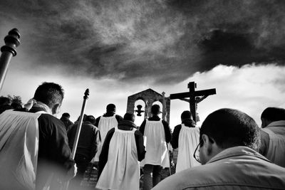 Man standing against cloudy sky