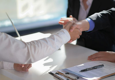 Colleagues shaking hands in office