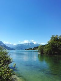 Scenic view of lake against clear blue sky