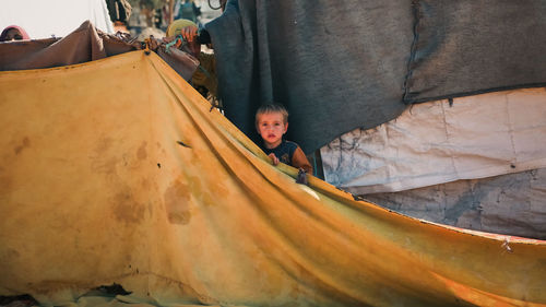 Syrian children inside their tent in the middle of a refugee camp near the turkish border.