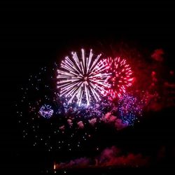 Low angle view of firework display at night