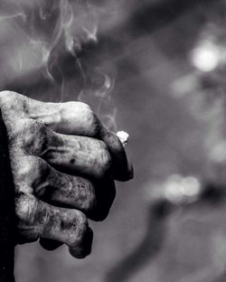 Close-up of human hand against blurred background