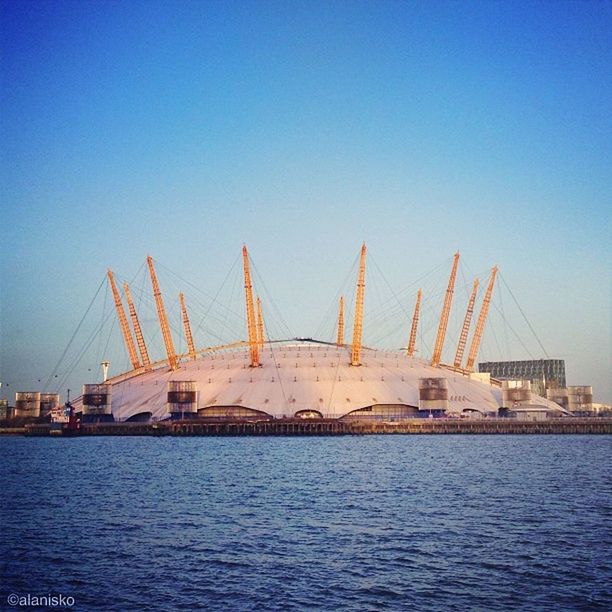 architecture, built structure, clear sky, water, waterfront, copy space, transportation, blue, connection, bridge - man made structure, river, engineering, travel destinations, travel, famous place, international landmark, nautical vessel, suspension bridge, building exterior, sea