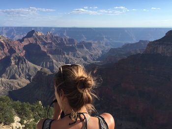 Rear view of woman and landscape against sky