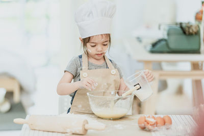 Girl holding ice cream at home