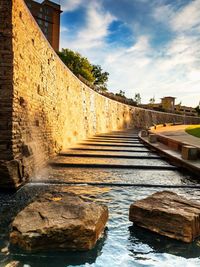 View of canal amidst buildings against sky