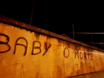 Close-up of information sign at night