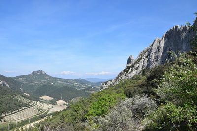 Scenic view of mountains against blue sky