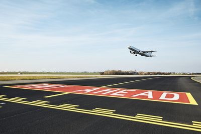 Traffic at airport. airplane taking off from runway during sunny day.