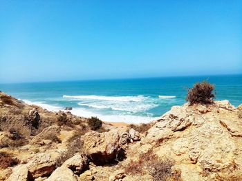 Scenic view of sea against clear blue sky