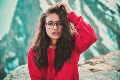 Portrait of beautiful young woman standing outdoors