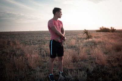 Man standing on field against sky