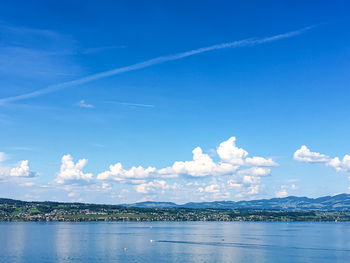 Scenic view of sea against blue sky