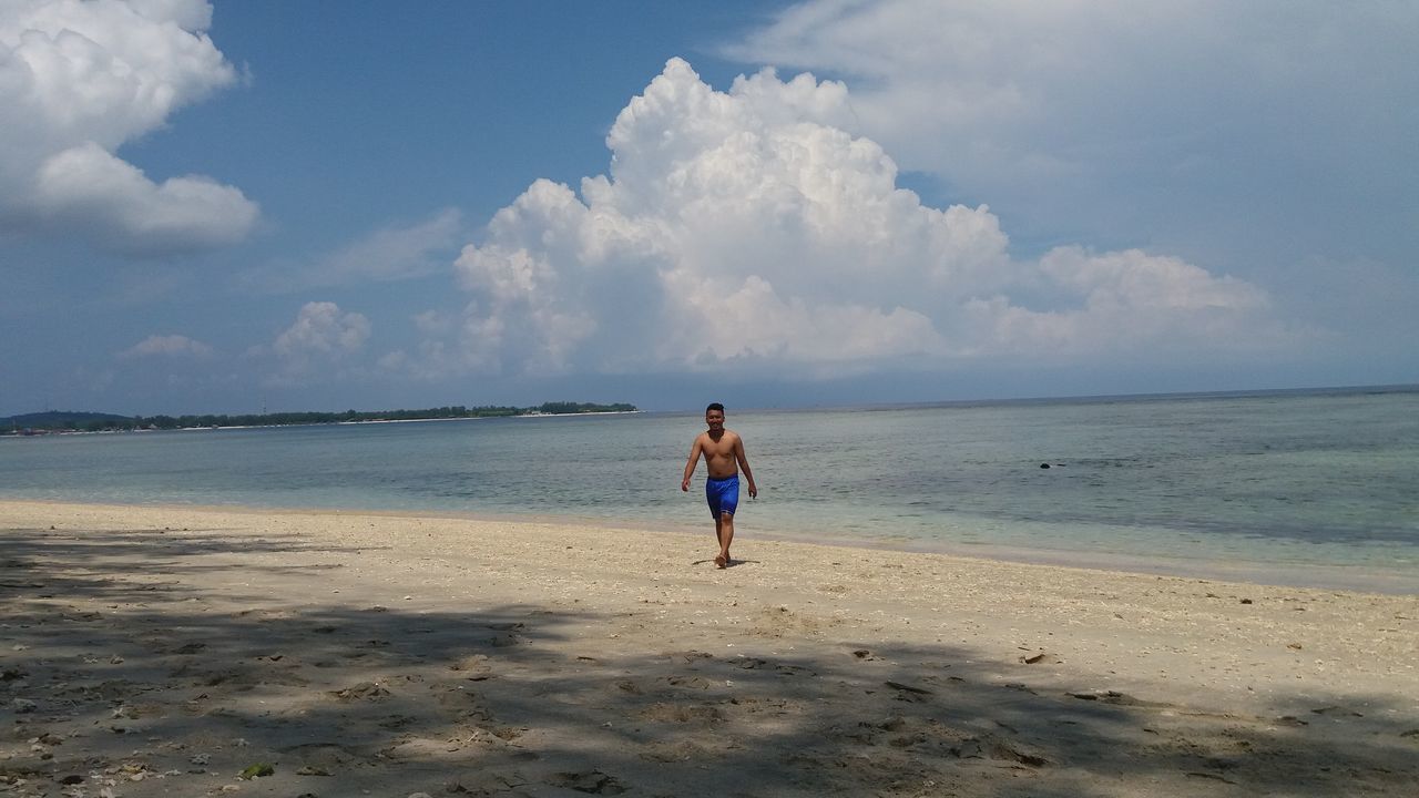 WOMAN STANDING ON BEACH