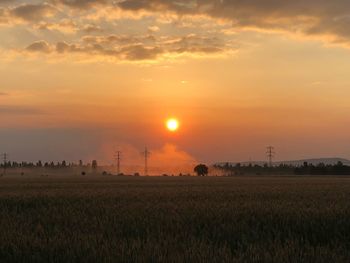 Scenic view of field against sky during sunset