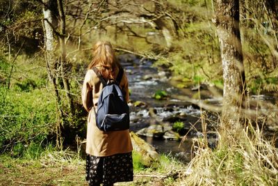 Portrait of young woman standing in forest