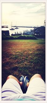 Low section of woman standing on field