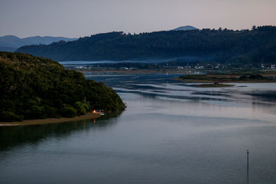 Scenic view of lake with mountains in background