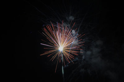 Low angle view of firework display at night