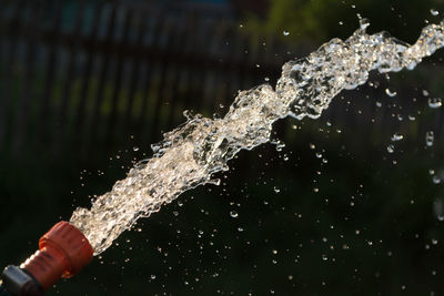 Close-up of water splashing on bottle